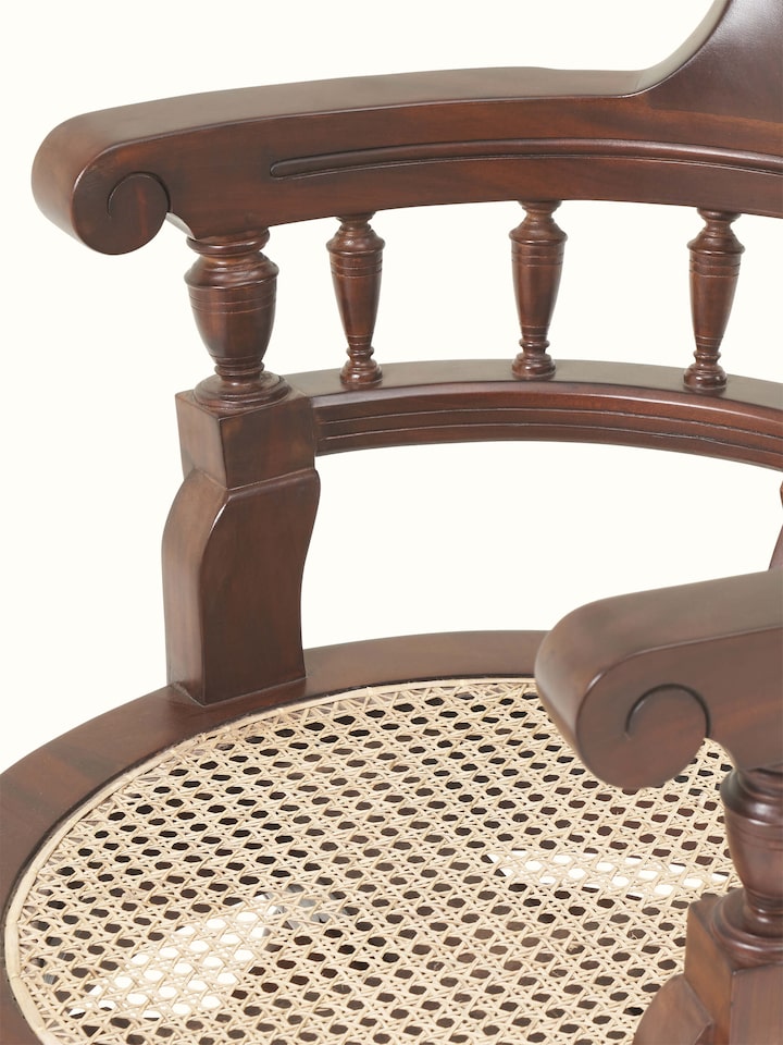 Detailed view of Mahogany wood and cane study chair emphasizing detailed cane work and wood joinery