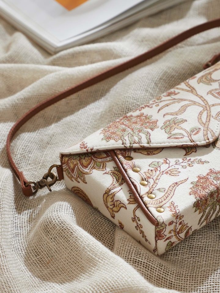 Side view showing mustard leather and block print textile sling bag profile