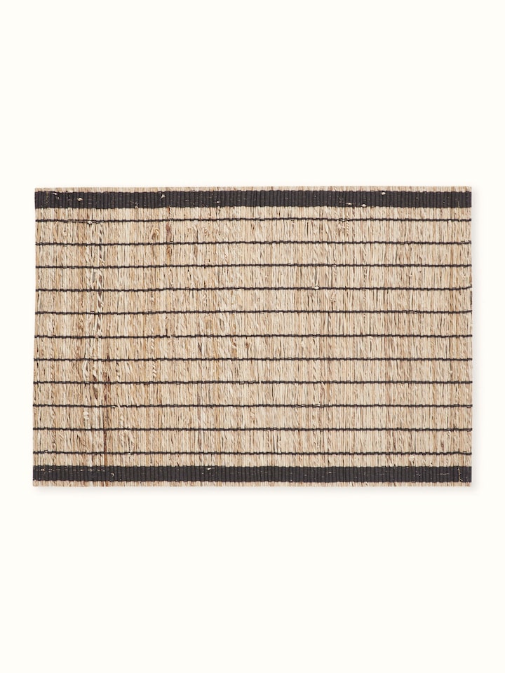 Angled close-up showing the natural banana fibre texture with bold black stripes