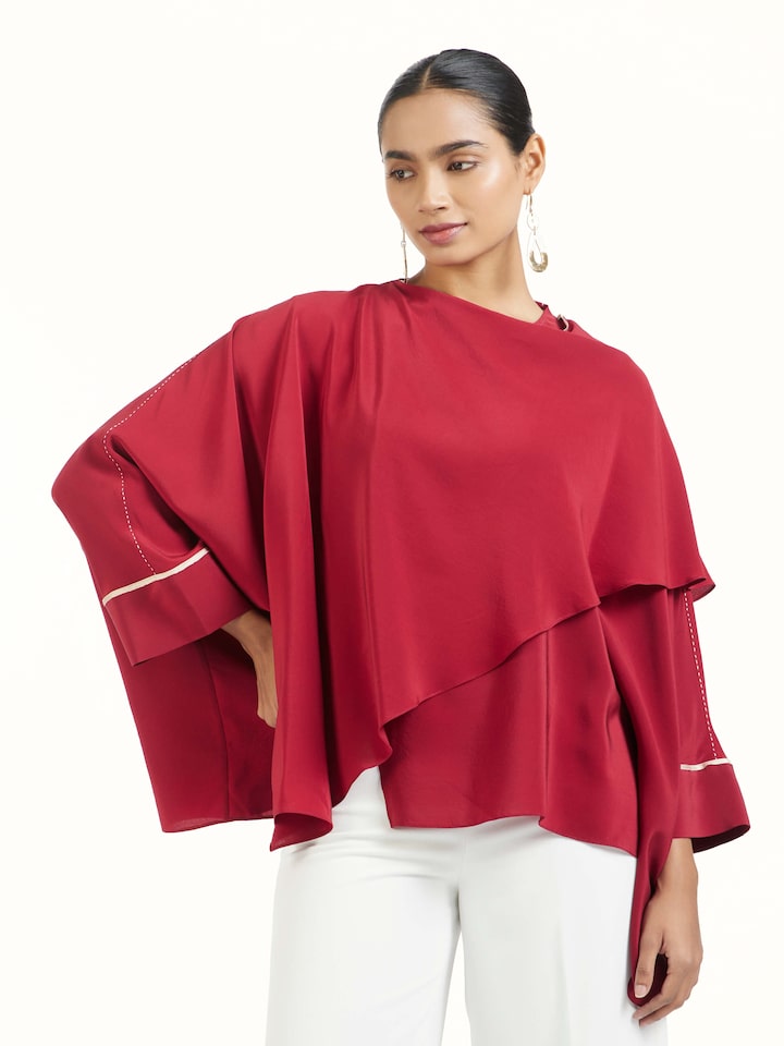 Angled view of red silk handloom top highlighting fabric texture