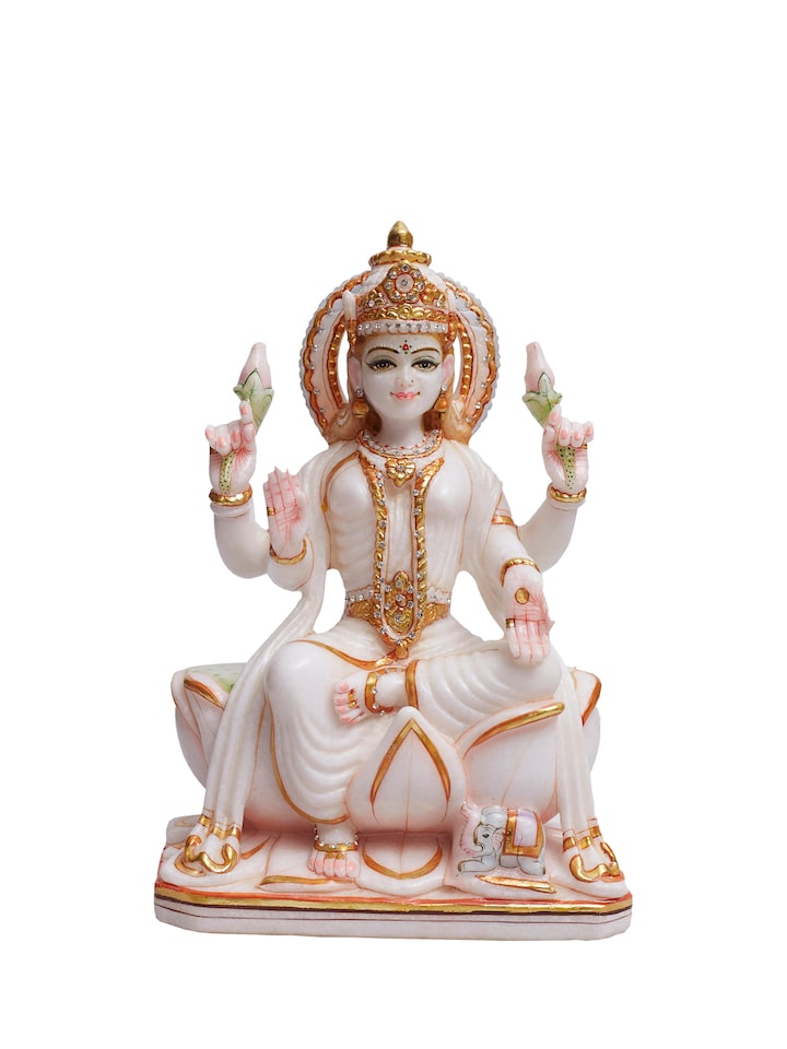 front view of carved marble lakshmi idol with intricate detailing