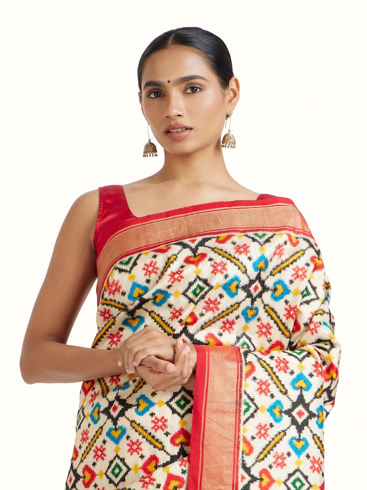 Angled view of Cream Double Ikat Silk Saree revealing the depth of its color and intricate pattern