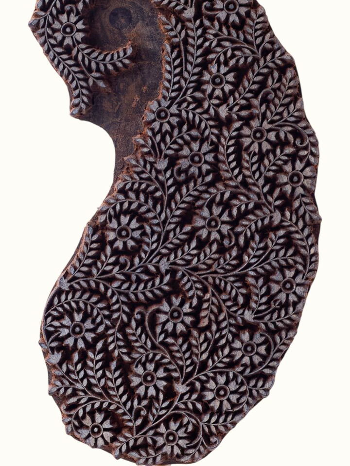 close-up view of sheesham wood carved paisley wooden block texture