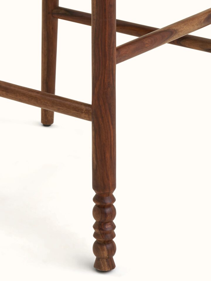 Close-up view of the Upholstered Sheesham Wood Bawan Buti Bar Stool emphasizing fabric texture