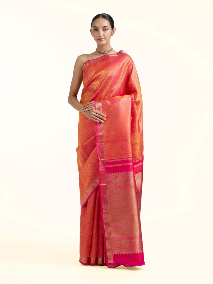 Front view of orange silk Kancheepuram saree with rich zari woven motifs