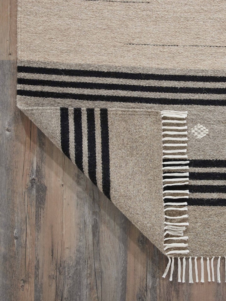 Detailed view of Nomad stripes beige black Jawaja wool & cotton handloom dhurrie (3x5 ft) showing the handloom craftsmanship and striped design