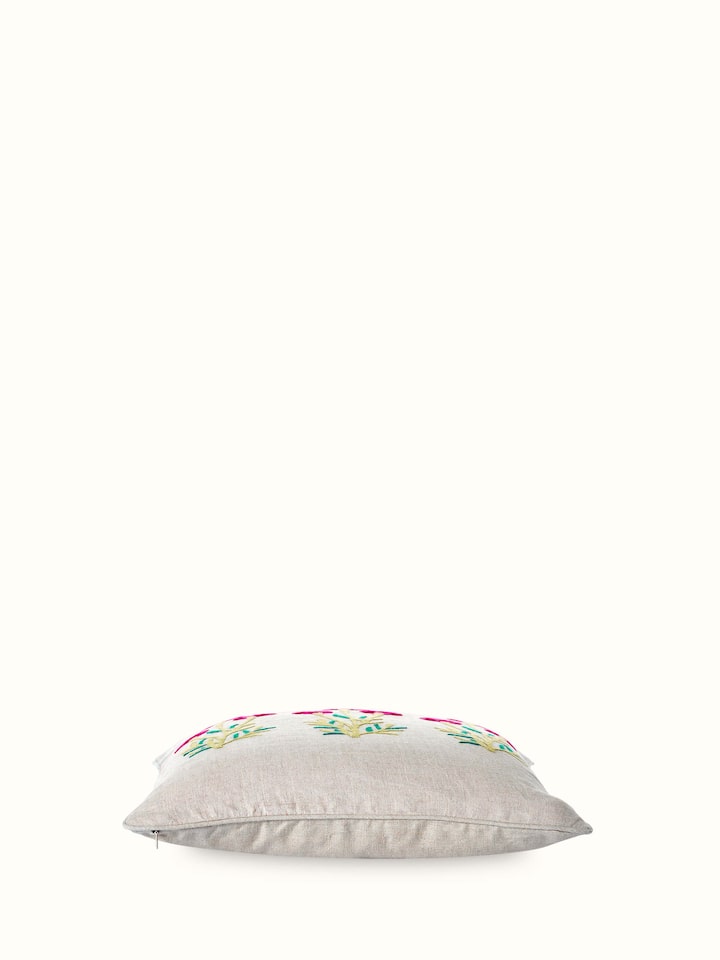 Angled view: Angled view of cushion showing embroidery depth and color richness.