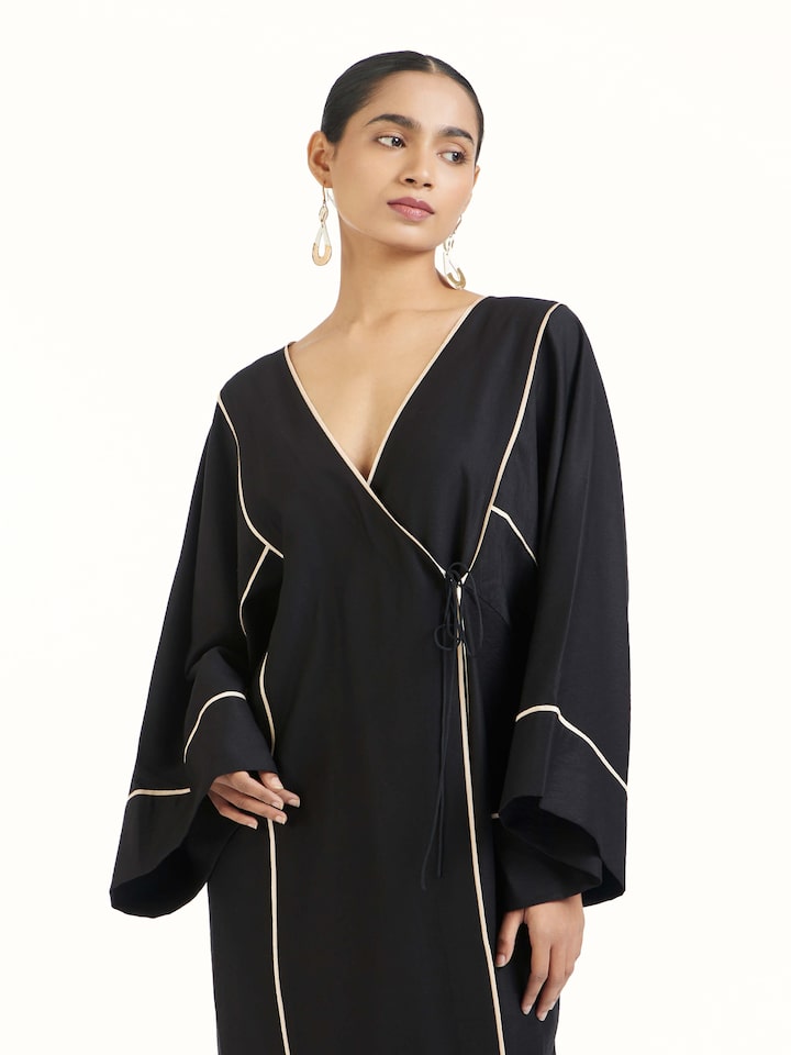 Angled view of black shibori kimono dress highlighting shibori dye work