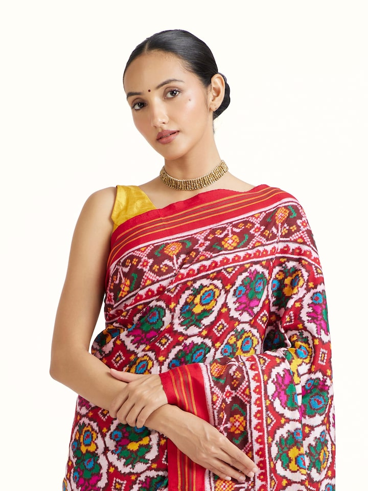Angled view of Red Patan Patola Saree revealing the depth of its color and intricate pattern