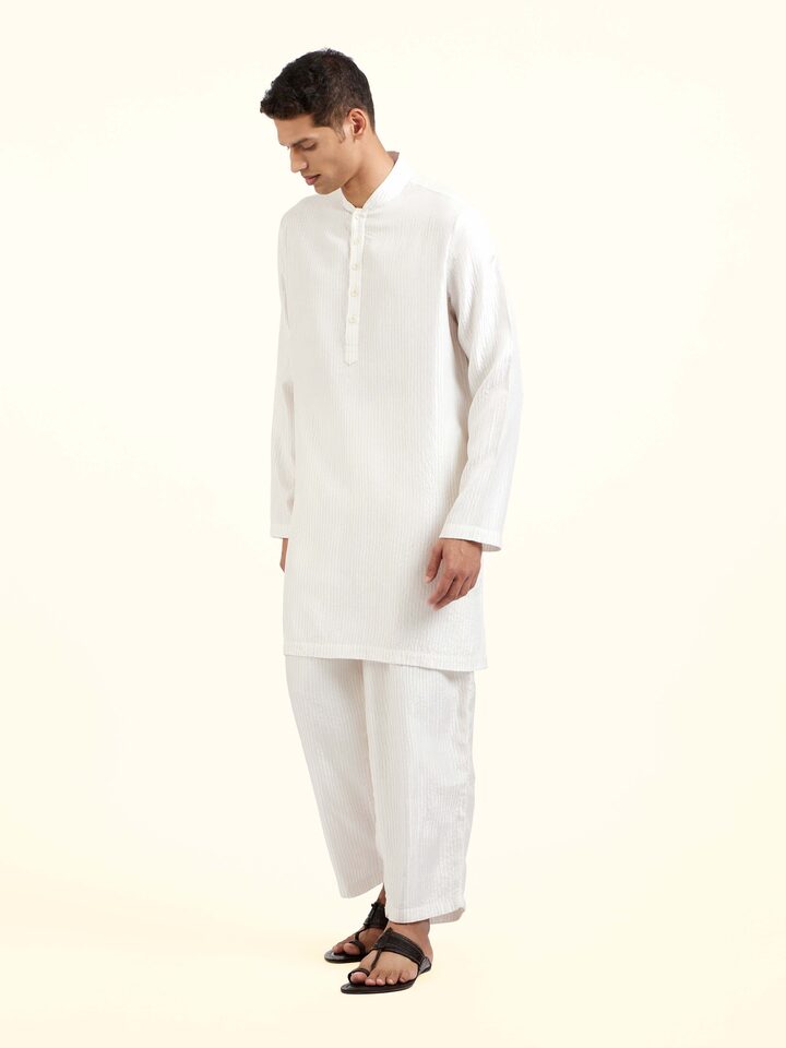 Side view of white silk quilting short kurta showing tailored silhouette