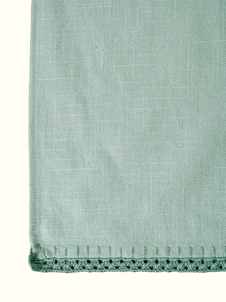 Detail view of Nityam Green Cotton Slub Crochet Table Runner highlighting the fabric texture and embroidery detail
