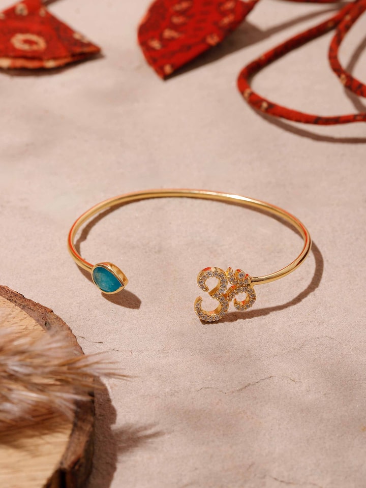 Close-up view of Green White Jade & Om 18K Gold Plated Silver Bracelet showcasing the contrast between green and white jade stones