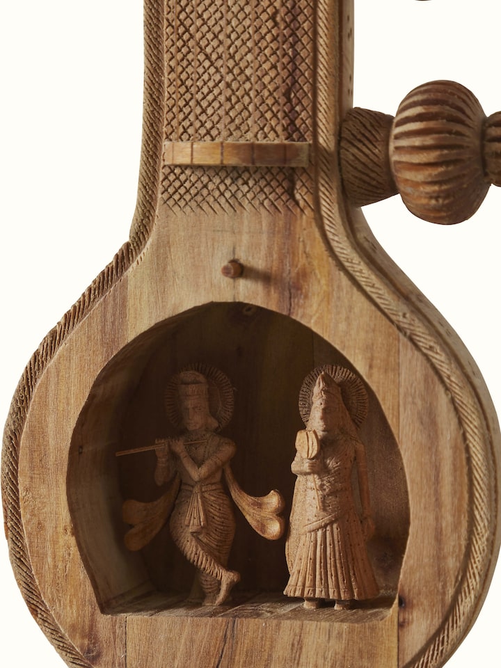 Detailed close-up of carved sandalwood Vandana Veena sculpture highlighting its artistic elements