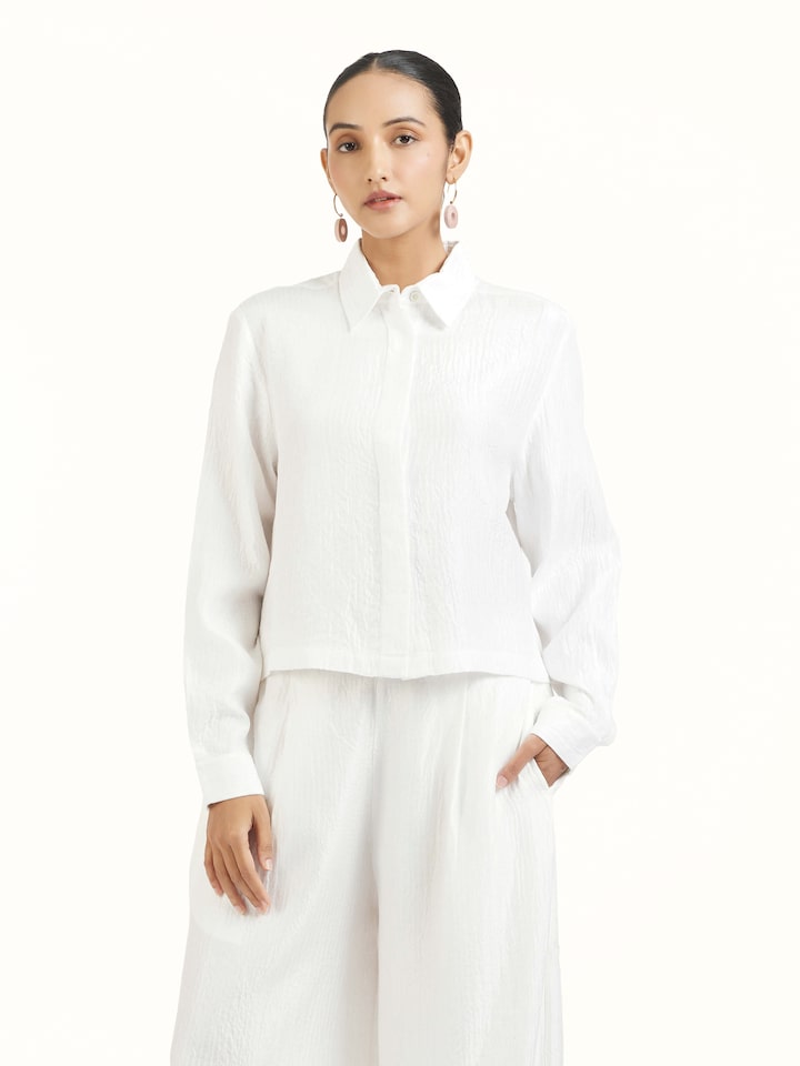 Angled view of ivory quilted silk pants highlighting quilted texture