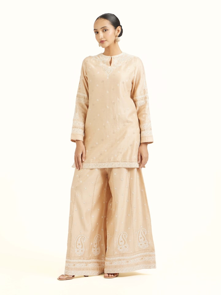 Side view of beige silk chikankari kurta showcasing tailored silhouette