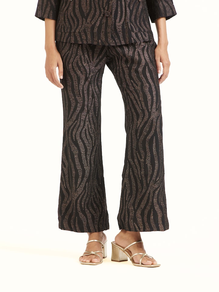 Angled view of black Aari hand embroidered pants highlighting embroidery details
