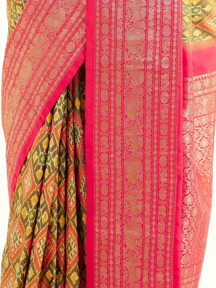 Detail view of green silk ikat saree showing silk texture and pattern clarity