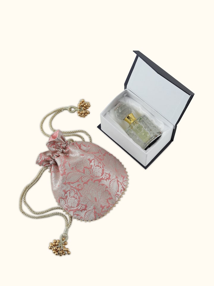 Overhead view of Rooh Gulab attar bottle with golden accents and glass finish