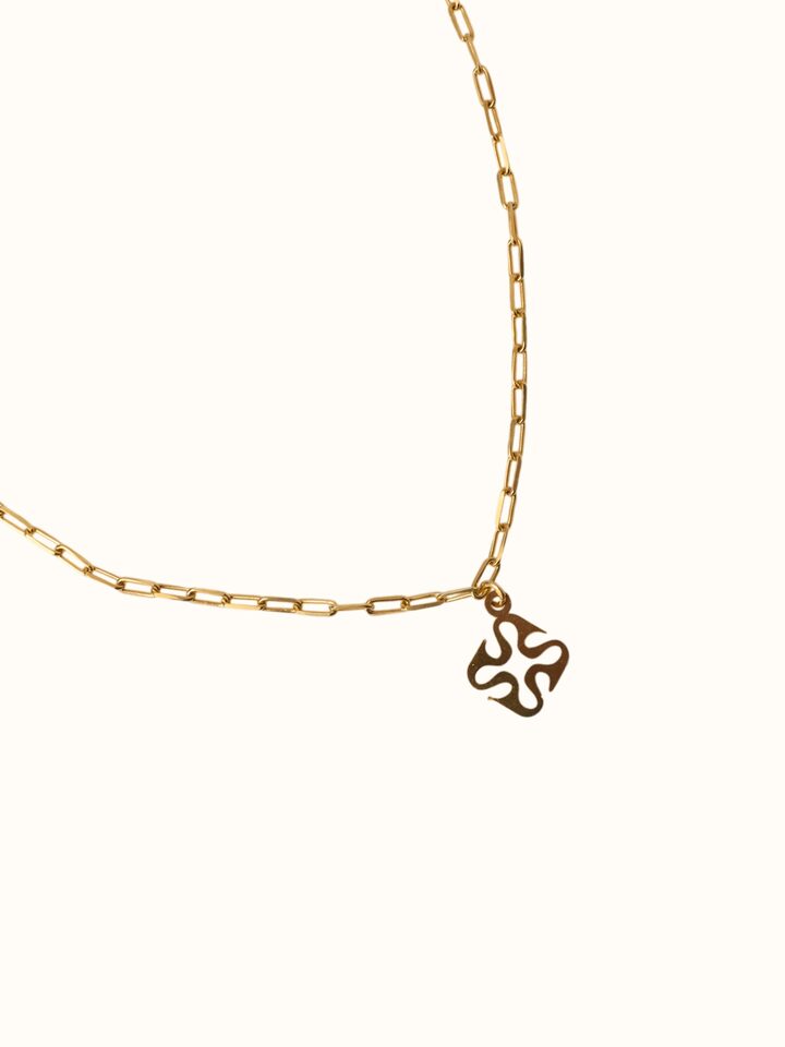 close-up view of carved wood and silver pendant chain detailing