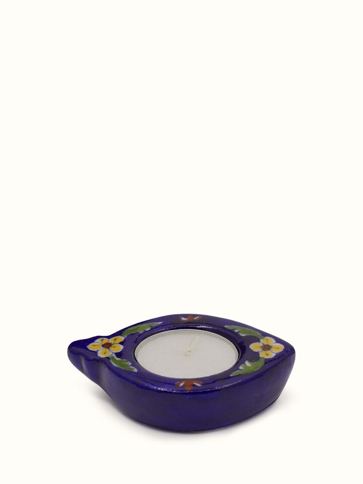 Blue pottery ceramic tea light holder with hand-painted floral design – angled view