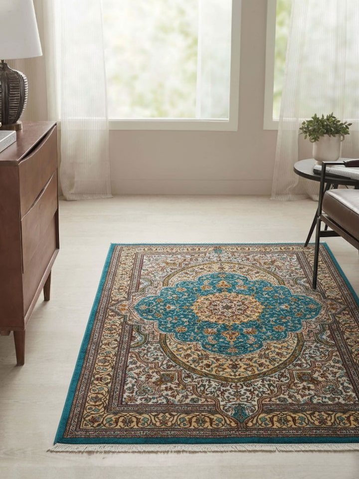 Traditional Persian blue Tabriz Kashmir silk hand-knotted carpet with intricate floral design, lifestyle view