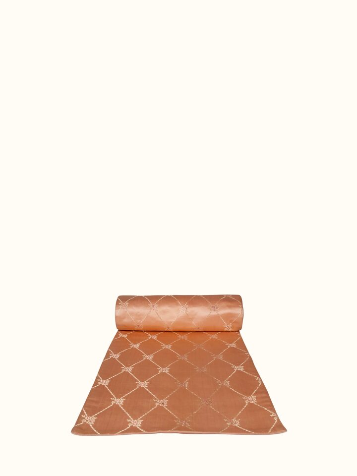 Angled view of Naman peach silk handloom table runner