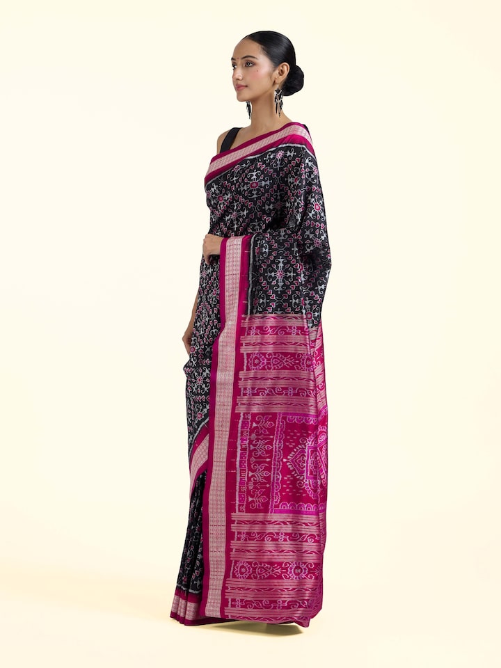 Side view of black mulberry silk Bandha Odisha Ikat saree highlighting structured drape and fabric texture