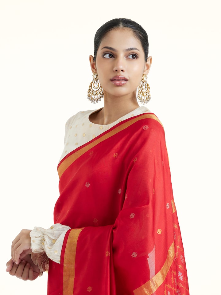 Angled view of red mulberry silk Uppada Jamdani saree highlighting jamdani weave