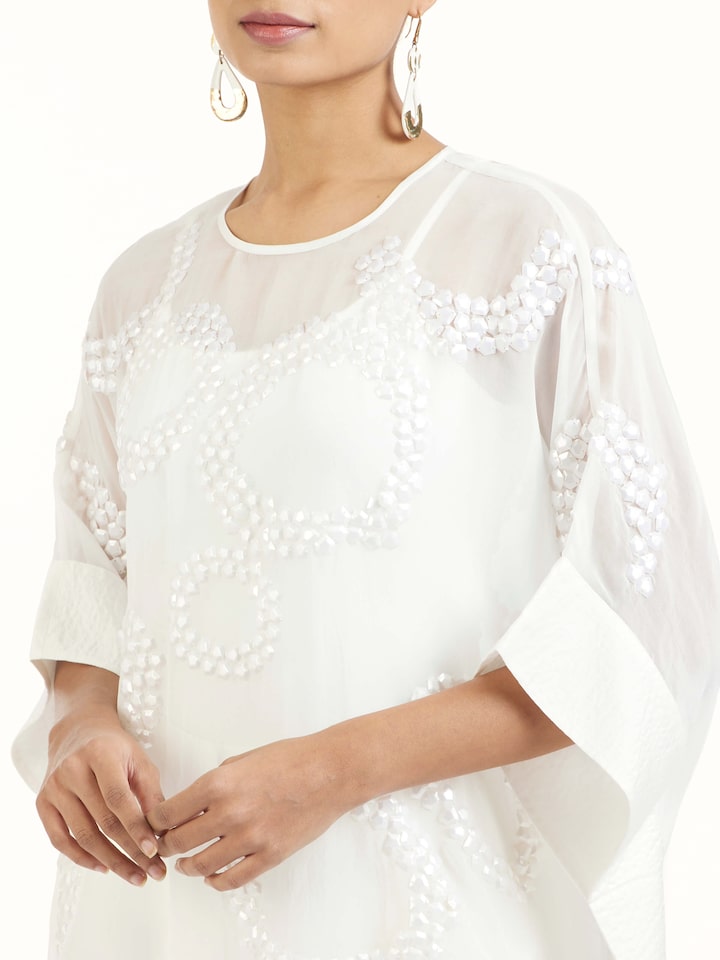 Detail view of ivory hand embroidered organza kaftan revealing fine craftsmanship