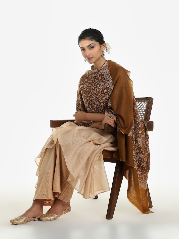 Side view of brown neemjali sozni embroidered shawl showcasing intricate needlework