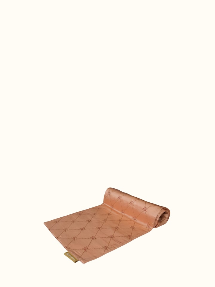 Angled close view of peach Banarasi brocade table runner