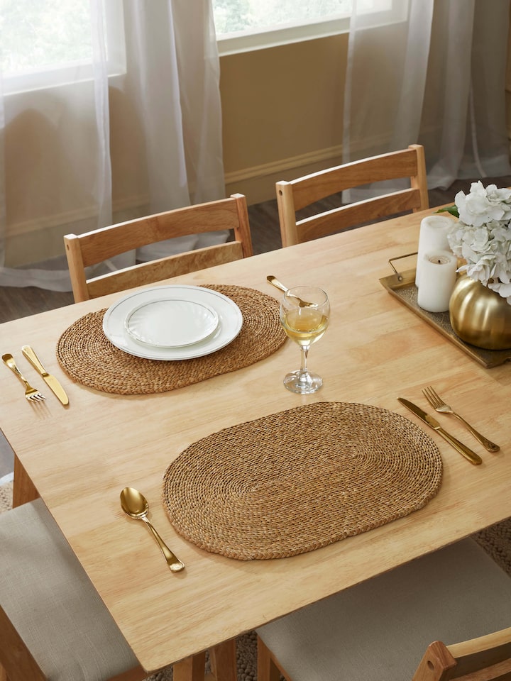 Close-up of Vritti brown solid oval natural fibre trivets, focusing on the intricate natural fibre weave.