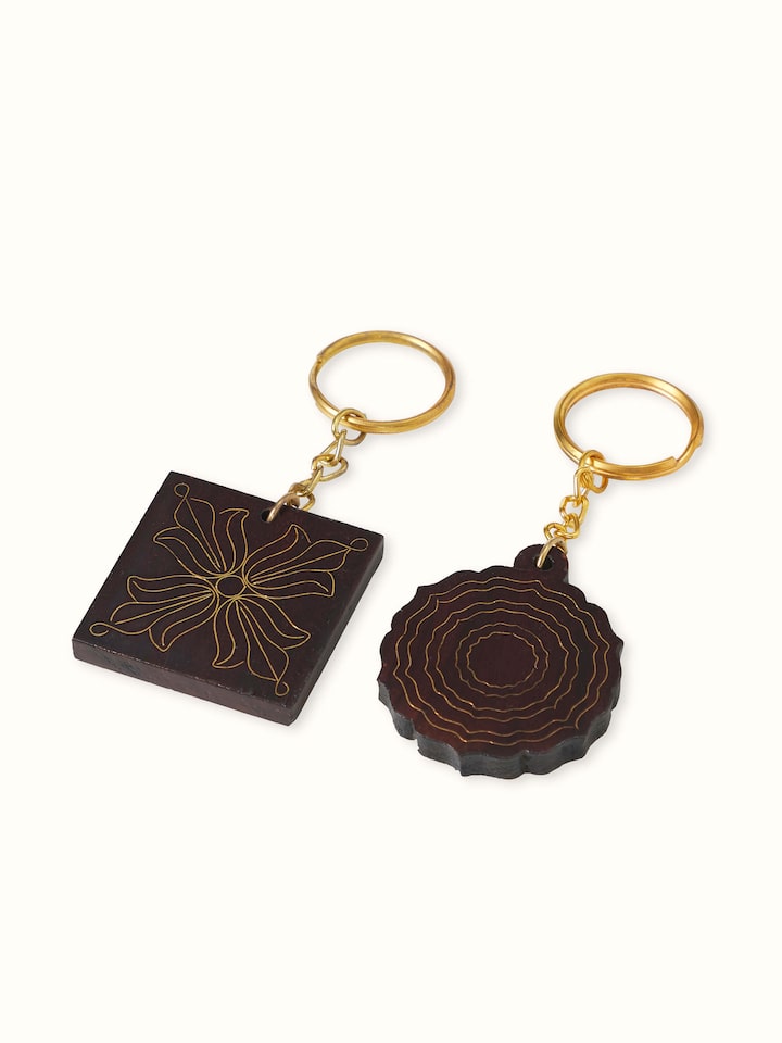 Angled view of Tarkashi Sheesham wood & brass keychains set showcasing both keychains’ craftsmanship