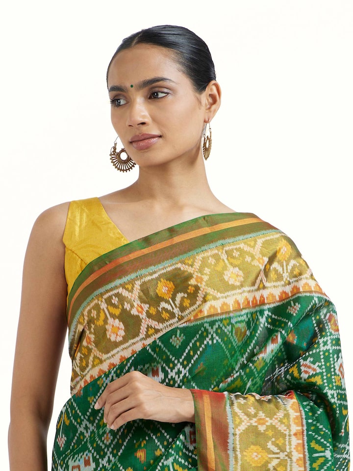 Angled view of Rajkot Patola Ikat Saree revealing the depth of its color and intricate pattern
