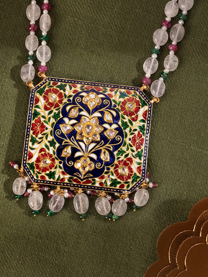 Close-up detail of Jaipur Meenakari gold pendant revealing fine craftsmanship and colourful hand-painted detailing.