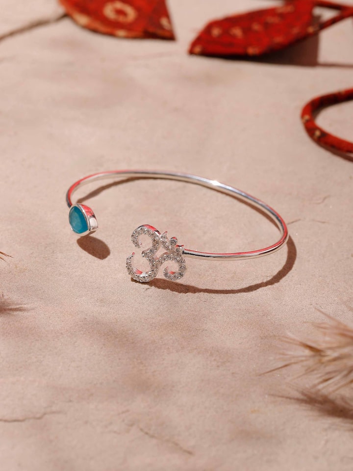 Side view of jade and Om charm bracelet worn casually, highlighting serene green and white hues