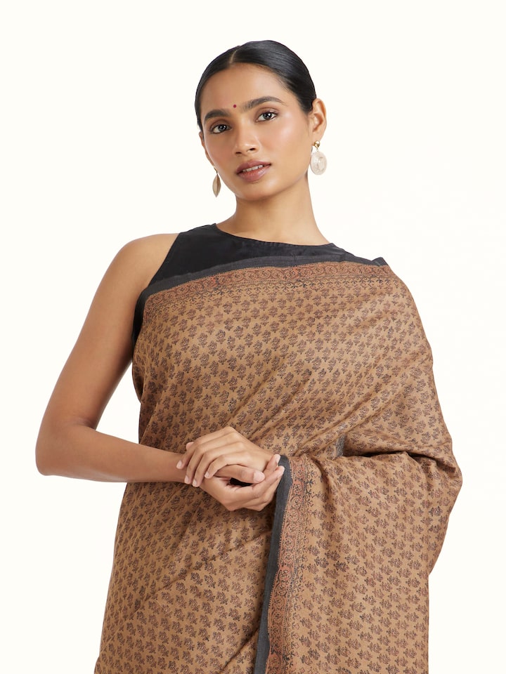Angled view of Beige Tussar Muga Silk Bagru Block Printed Saree revealing the depth of its color and intricate pattern
