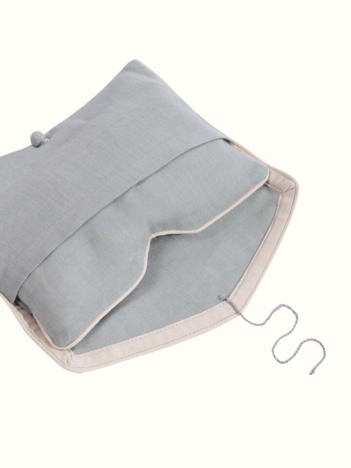 Detail view of Flaxseed and Lavender Eye Pillow Light Green highlighting the fabric texture and embroidery detail