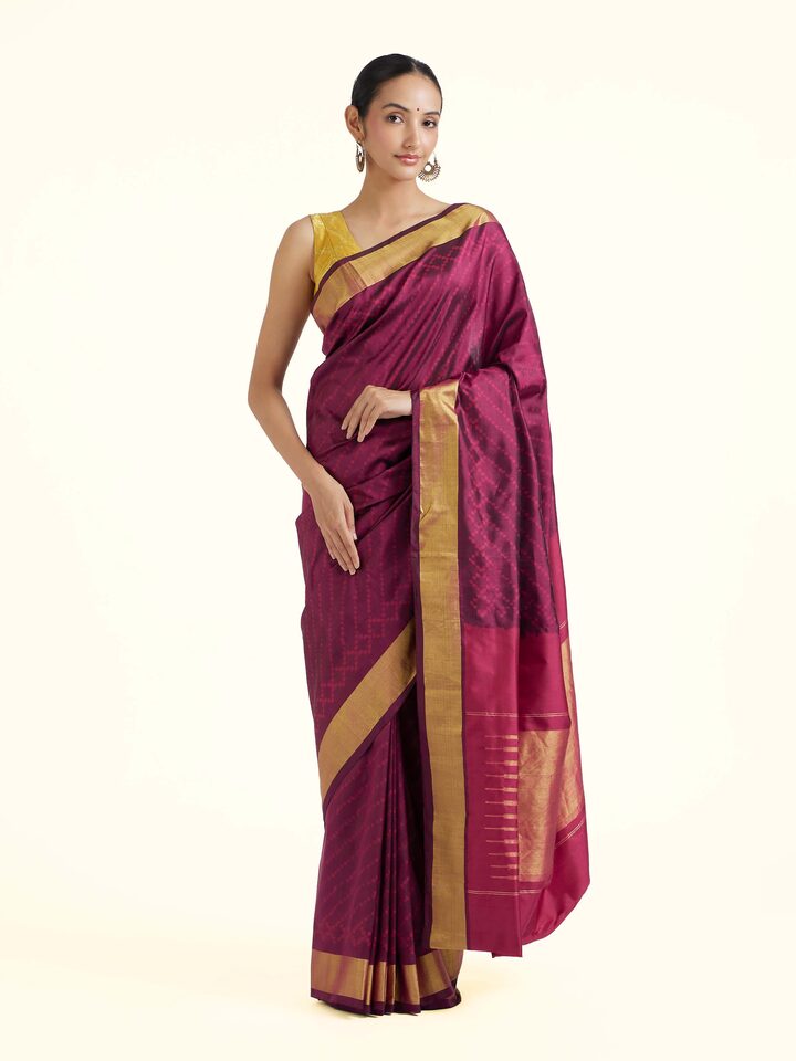 Front view of purple mulberry silk ikat saree with traditional woven motifs