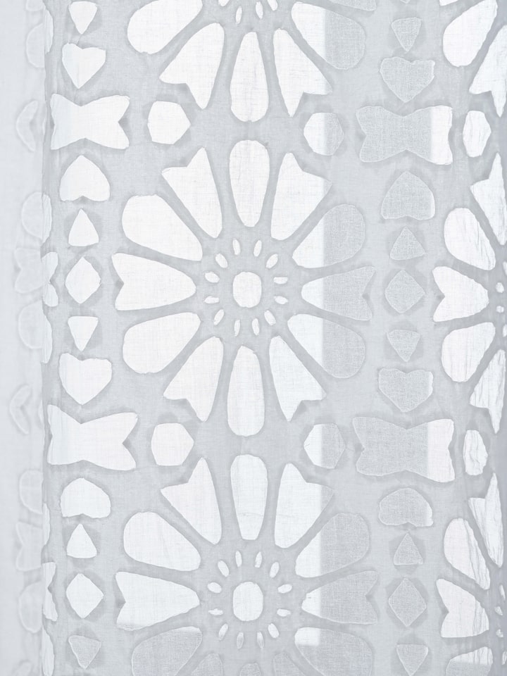Side angle view showcasing texture and layered appliqué motifs on Mandana curtain