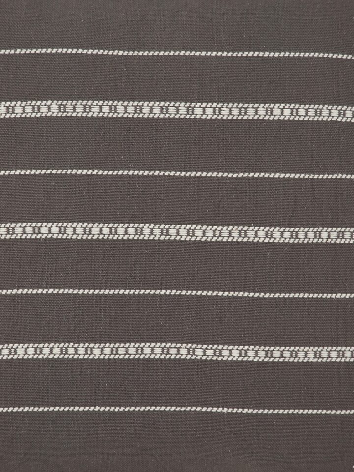 Detailed shot capturing the precision of the Bhujodi motifs and natural cotton fabric
