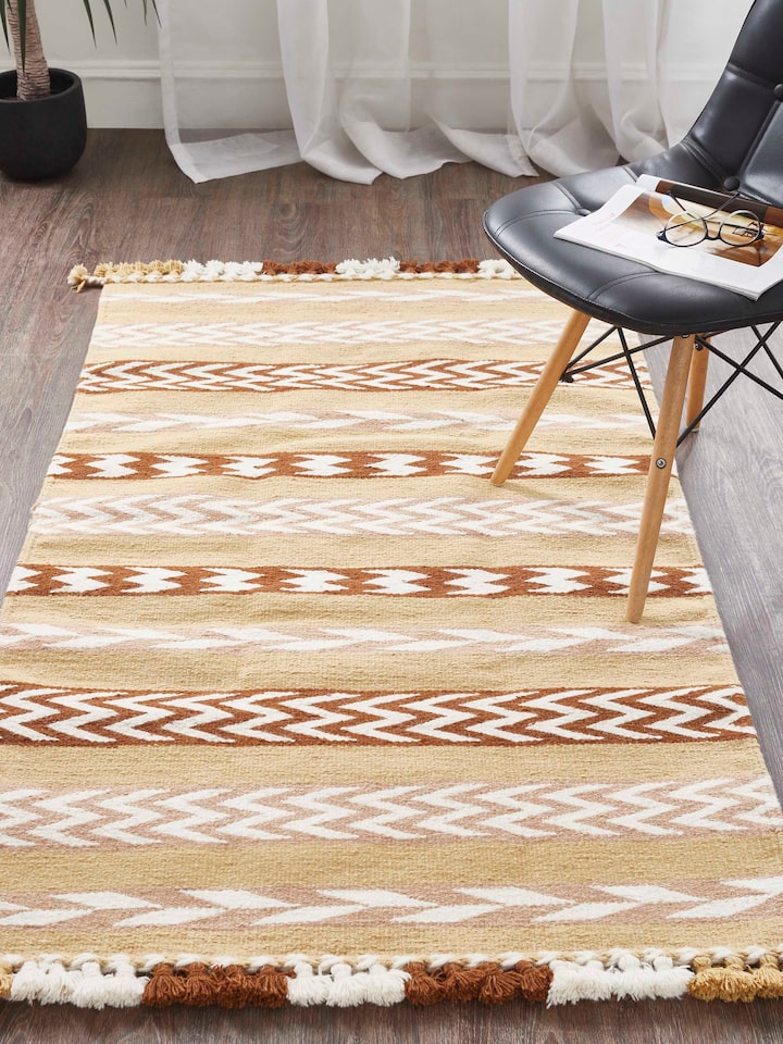 Side view of Chevron Stripes Yellow Gujarat Wool & Cotton Panja Dhurrie Kharad highlighting the design and texture.