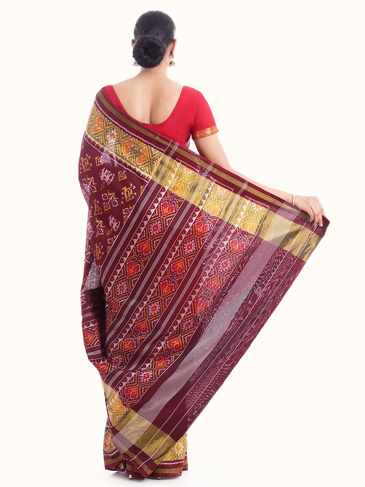 Back view of red silk patola saree emphasizing the full length and design