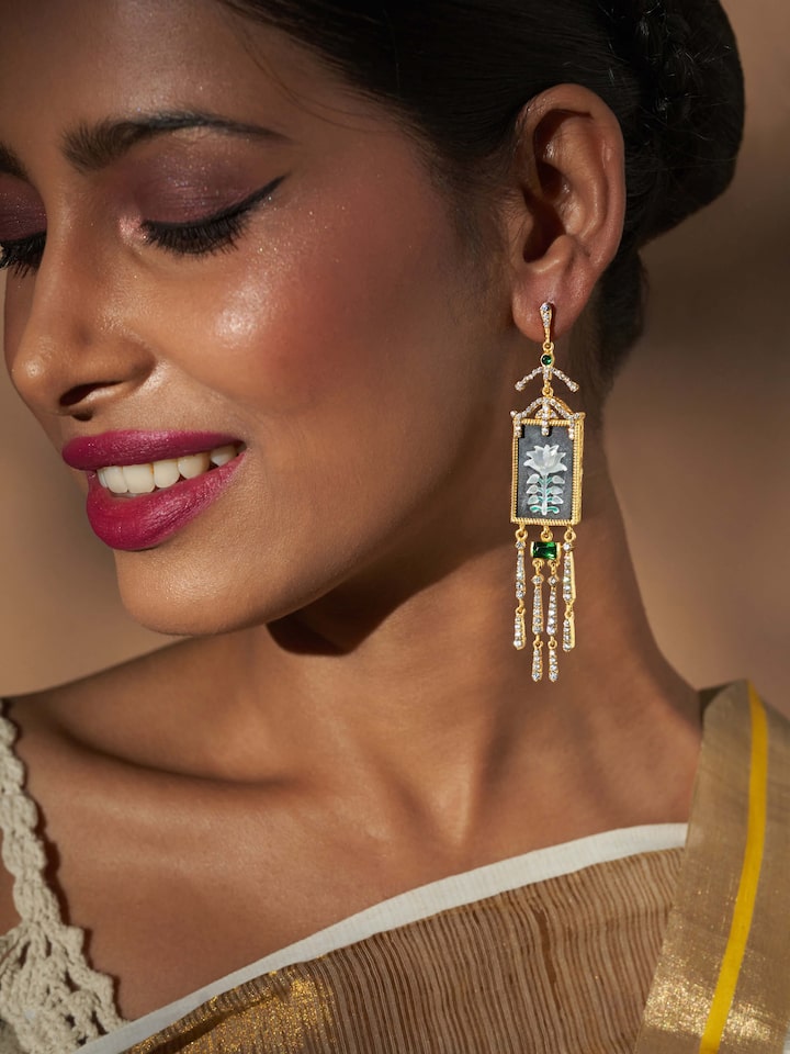 Styled detail view of Parchinkari Silver Drop Earrings worn on the ear, shown in another styled shot