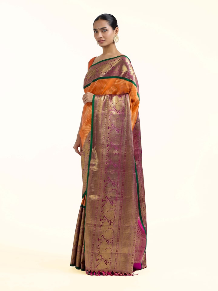 Side view of mango silk Kancheepuram saree showcasing contrast border