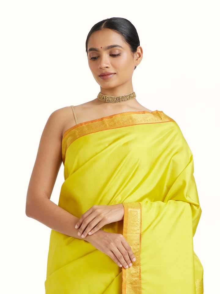 Angled view of Mustard Silk Dharmavaram Saree revealing the depth of its color and intricate pattern