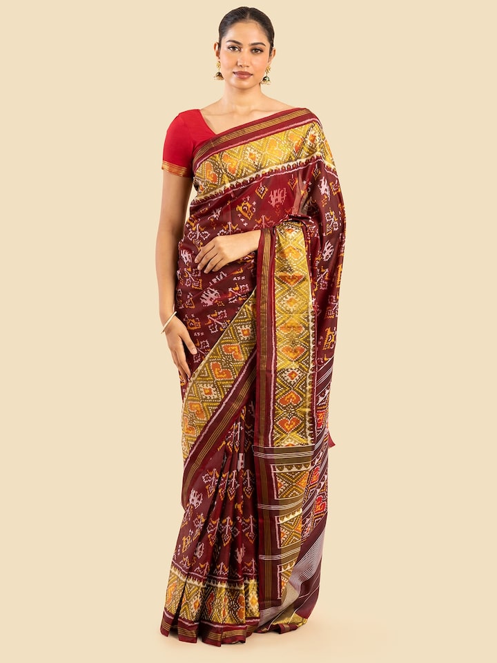 Side view of red silk patola saree showing intricate detailing and fabric texture