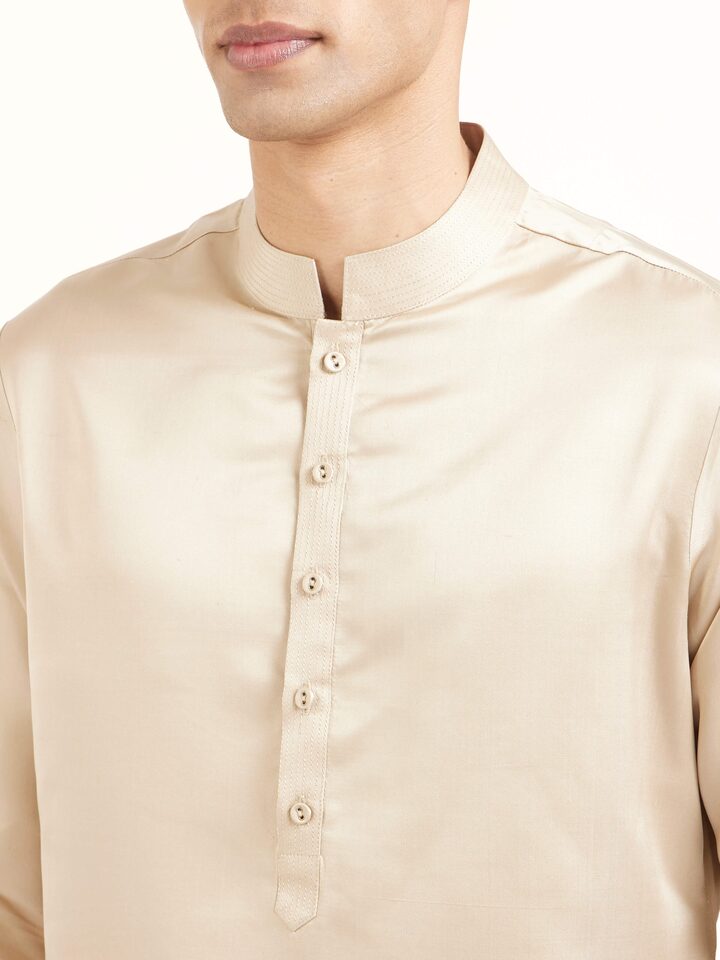 Detail view of beige katan silk Banarasi long kurta churidar set showcasing intricate fabric texture