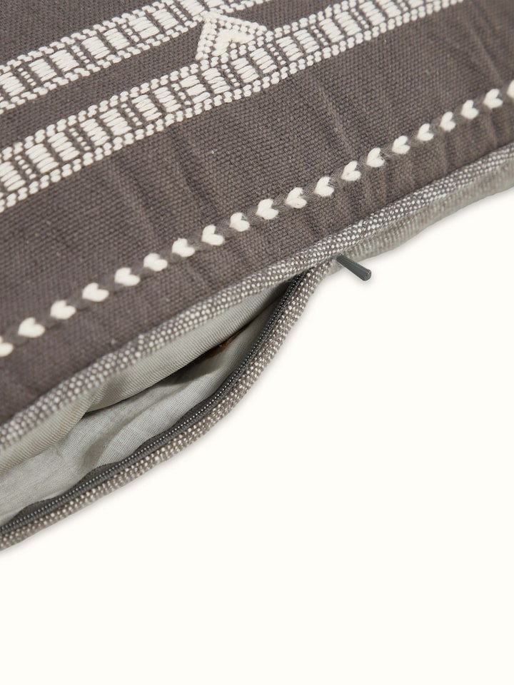 Angled view of Anek Coffee Handloom Cushion Cover showcasing pattern and structure