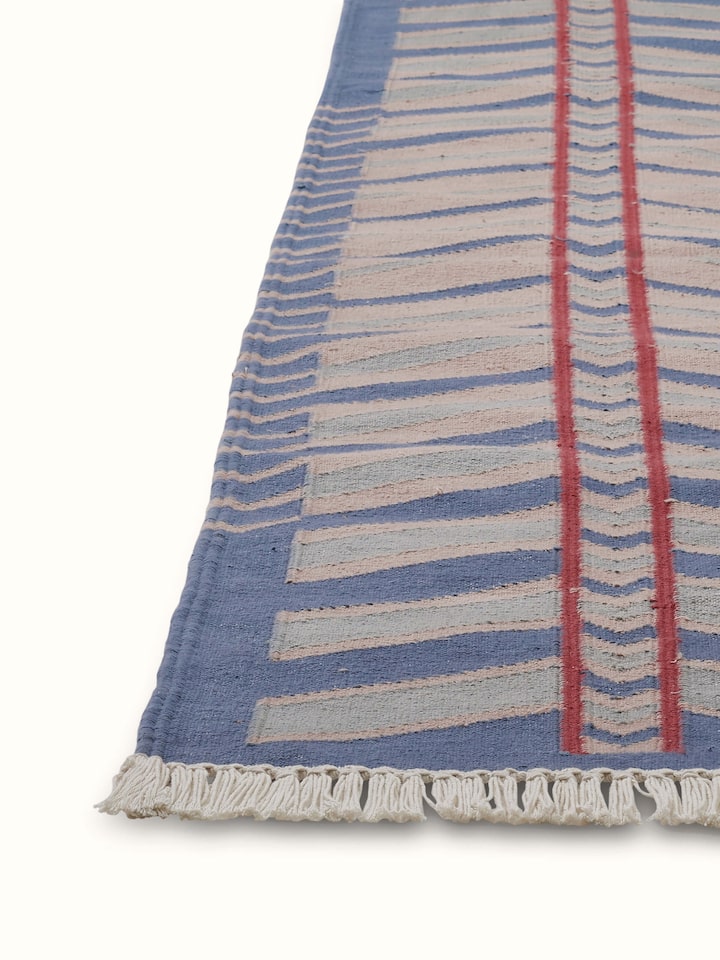 Detailed view of Geo chevron gradation blue beige lawan cotton panja dhurrie showing the chevron pattern and fabric quality.